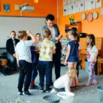 Dzieci układają puzzle na dywanie