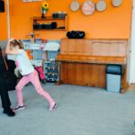 Dziewczynka wykonuje gest ochronny przed uderzeniem w głowę