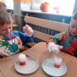 dwoje dzieci bawi się pianą