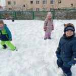 grupa dzieci stoi na śniegu